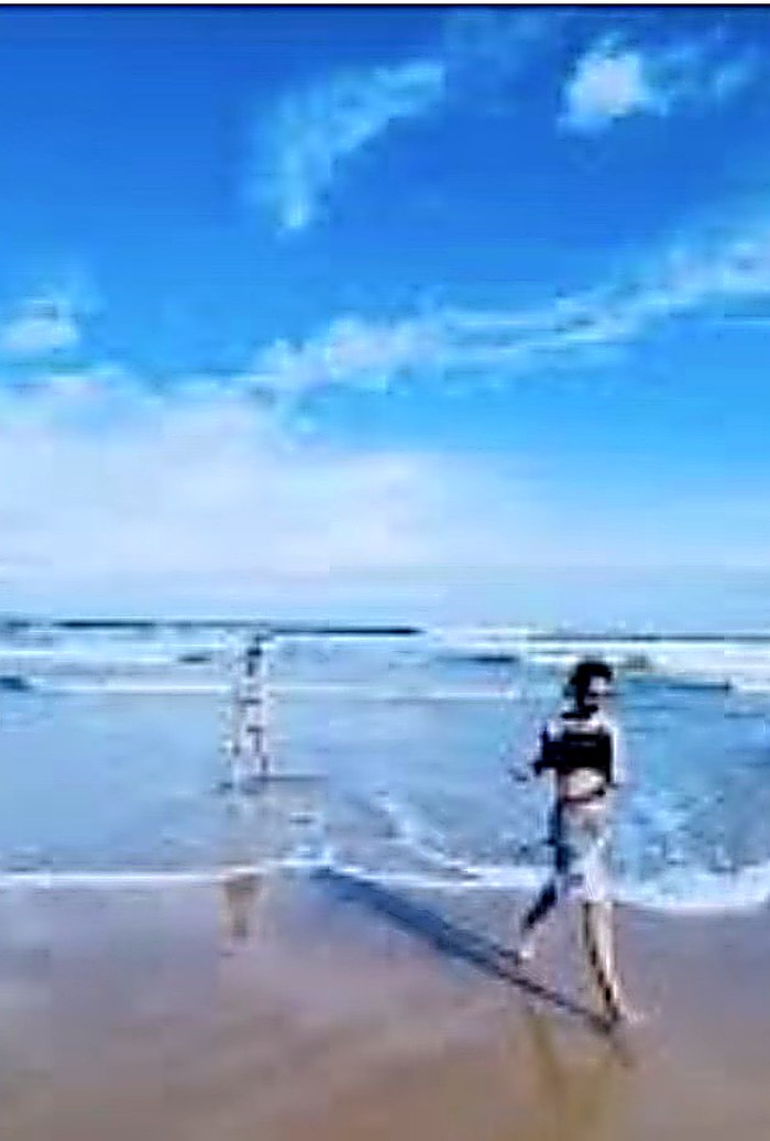 Guest walking along the beach at sunrise